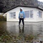 Mary Allison checks on her next door neighbour's property after heavy rainfall at Long Beach on...