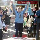 Mary Herbison, of Dunedin, takes a walk along the red carpet in George St after swapping her...