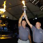 Sir Colin Meads and Dick Tayler lighting the torch.