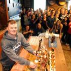 Mathew Beard (27), of Sydney, learns to pour a beer while his Contiki tour party group samples...