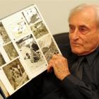 Maurice Davis with a scrapbook of photographs from the New Zealand Andes Expedition's successful...