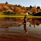 Max Dunjey (2) tries his luck at fishing in flooded Orana Park in Oamaru yesterday. All he caught...