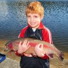 Max West (5) with his first fish, caught at Dunedin's Southern Reservoir yesterday. Photo by...