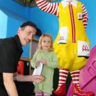 McDonald's employee Alan Garthwaite is in his element as he hands a toy to Evie O'Dowda (2)....