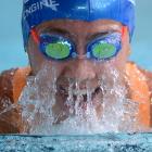 Meg Sycamore takes a breath on her way to winning the girls 13-14 years 100m breaststroke during...