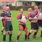 Members of the Eastern Districts Old Devils side attempt to intimidate their opponents at the...