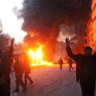 Men react near a site hit by what activists say are barrel bombs dropped by government forces on...