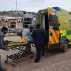 Men transport a casualty after car bomb attacks occurred at the Bab al-Hawa border crossing...