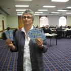 Methodist Mission chief executive Laura Black holds fake money she used as a prop during annual...