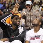 Miami Heat James and Wade sit on bench against Dallas Mavericks late in NBA basketball game in...