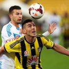 Michael Boxall of the Phoenix holds off the challenge of the Victory's Kosta Barbarouses. Photo...