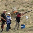 Michael Gould, of New Zealand, sights his target while Bruce Scott (left), of Auckland, Scott...