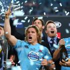 Michael Hooper (C) celebrates with Waratahs teammates after beating the Crusaders in the Super 15...
