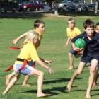 Michael Munro-Thomas, of Queenstown Primary School, battles his way through Clyde defenders (from...