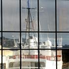 Michael Swann's vessel Townsend Cromwell, berthed at Dunedin's Birch St wharf, reflected in the...