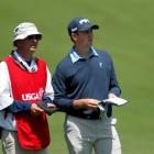 Michael Thompson of the US consults with his caddie on the 16th hole during the first round of...