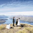 Mike and Jan Borden exchange wedding vows at their ceremony, conducted by Bev Clark above Lake...