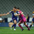 Mike Delany of the Highlanders makes a break against the Bulls during their Super 15 match at...