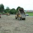 Mike Hurring Contractors staff dump and grade loads of gravel over the old Dreaver Courts site in...