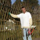 Mike Lilian beside the woven willow screen he has created at the Waitaki Community Gardens. Photo...