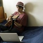 Mike Nourie, 20, plays guitar and sings in his dorm room at Emerson College in Boston. Nourie...