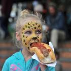 Millie McNamara (5), of Tapanui, tucks into a hot dog during Thieves' Alley Market day.