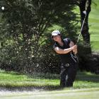 Monica Tulisi attacks the pin from a greenside bunker at the 17th during play in the Otago...