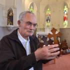 Monsignor John Harrison with ornamental crosses snapped from choir stools in the St Joseph's...