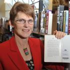 Mosgiel Library manager Linda Roxburgh displays a new radio frequency identification tag on a...