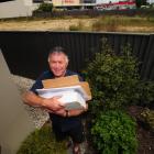 Mosgiel resident Malcolm Anngow with the file he is building up opposing plans for a McDonald's...