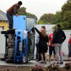 Motorist Mike Stone stands on a car which flipped in Dee St, Invercargill, yesterday  morning. ...
