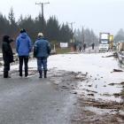 Motorists wait for State Highway 1 to reopen over Big Kuri Creek just north of Hampden on...