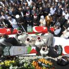 Mourners pray by the coffins of victims of the Israeli naval commando raid, as they are carried...