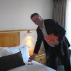 Mr McIlwain places a portion of Marmite on one of the guests' pillows at the resort yesterday....