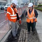 MWH project manager Cassino Doyle stands with  archaeologist Jill Hamel near the Dunedin Railway...