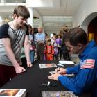 Nasa astronaut and retired US Air Force Colonel Rex Walheim signs his autograph for Harrison...