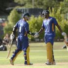 Nathan McCullum (left) is congratulated by Dimitri Mascarenhas after reaching his 50 at the...