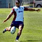 New Highlanders first five-eighth Lima Sopoaga practises his drop kicking during team training at...