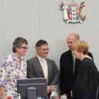 New JPs (from left) Laura Black, Dave Cull and Gary Johnson listen to Judge Mary O'Dwyer...