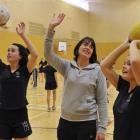 New Steel co-coach Janine Southby passes on a few tips to Columba College pupils Georgia Nichol ...