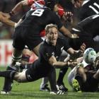 New Zealand All Blacks' Andy Ellis passes the ball from the base of a scrum during their Rugby...