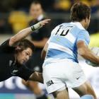 New Zealand All Blacks' captain Richie McCaw (left) tackles Argentina Pumas' Juan Martin...