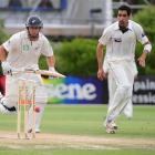 New Zealand batsman Ross Taylor (right) watches as the ball hits the stumps to run him out for 59...