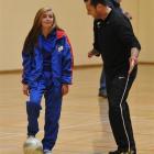 New Zealand Football standards manager Dwayne Wooliams (right) talks to Queen's High School pupil...