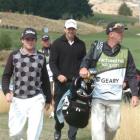 New Zealand golfer Josh Geary (left) and his brother and caddy, Brad, walk to the ninth tee...