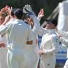 New Zealand players celebrate the wicket of Kirk Edwards, out for a duck, yesterday. Photo by...