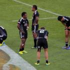 New Zealand players show their disappointment after losing to Kenya.(Photo by Hagen Hopkins/Getty...