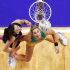New Zealand's Bailey Mes (L) and Australia's Julie Corletto in action during their World Cup...