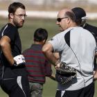 New Zealand's Daniel Vettori, left, talks to outgoing coach Mark Greatbatch during a net practice...