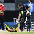 New Zealand's Grant Elliot (R) helps South Africa's bowler Dale Steyn up after New Zealand won...